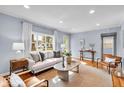 Bright living room featuring hardwood floors, a neutral sofa, stylish decor and lots of natural light at 4914 Indianola Ave, Indianapolis, IN 46205