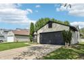 Single-Gathering home featuring a two-car garage, porch, and landscaping at 5323 Shefford Ct, Indianapolis, IN 46254