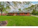 Lovely single-story brick home with a large front lawn and mature trees, giving it a cozy feel at 5846 Linton Ln, Indianapolis, IN 46220