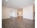 Spacious living room offering a view into the kitchen and staircase access at 6216 Cascades Dr, Whitestown, IN 46075