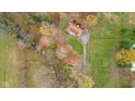 Aerial view of a home surrounded by lush foliage and a stream, showcasing its private setting at 647 N 100 W, Franklin, IN 46131