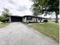 Charming single-story home features a spacious yard, attached garage, and lovely landscaping at 6811 S Meridian St, Indianapolis, IN 46217