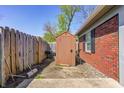 Private backyard featuring wooden shed, storage, and garden space at 6814 Summer Time Dr, Indianapolis, IN 46226