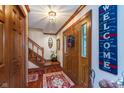 Inviting foyer with hardwood floors, a staircase, and a decorative wreath on the front door at 7020 N 375 E, Lebanon, IN 46052