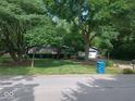 Beautiful home with lush green lawn, mature trees and landscaping at 8728 Holliday Dr, Indianapolis, IN 46260
