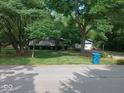 Beautiful home with lush green lawn, mature trees and landscaping at 8728 Holliday Dr, Indianapolis, IN 46260
