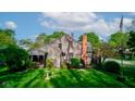 Expansive backyard featuring a well-maintained lawn, mature trees, and a classic brick chimney at 901 Center Dr, Noblesville, IN 46060