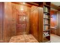 Inviting entryway with beautiful wood paneling, tile flooring, and convenient built-in storage at 901 Center Dr, Noblesville, IN 46060