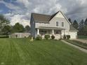 Expansive front yard features a lush lawn, complemented by mature trees at 10691 Morristown Ct, Carmel, IN 46032