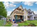 Two-story home featuring a second-floor balcony, complemented by a cozy front porch at 1121 Eugene St, Indianapolis, IN 46208