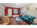 Stylish living room featuring vibrant red accent wall, plush blue sofa, and unique decor at 1121 Eugene St, Indianapolis, IN 46208