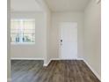 Inviting entryway with wood-look floors and a window providing natural light at 113 Hunter'S Rdg Dr, Danville, IN 46122
