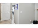 Hallway featuring neutral paint, light-colored vinyl flooring, and a view into the bedroom at 11716 Whisper Cove Dr, Fishers, IN 46037