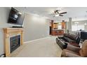Comfortable living room featuring a fireplace, media center, and an open layout to the kitchen at 11716 Whisper Cove Dr, Fishers, IN 46037