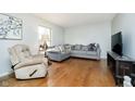 Cozy living room showcasing hardwood floors, a plush sofa, and natural light at 162 Carmelaire Dr, Carmel, IN 46032