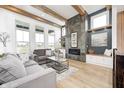 Stylish living room with a modern fireplace, comfortable seating, and bright natural light at 16457 Gleneagles Ct, Noblesville, IN 46060