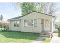 Charming home with verdant lawn, and a welcoming front entrance showcasing its curb appeal at 1725 Medford Ave, Indianapolis, IN 46222