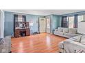 Spacious living room with light blue walls, wood floors and a large sofa, perfect for relaxing and entertaining at 1725 Medford Ave, Indianapolis, IN 46222