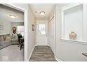 Welcoming entryway with neutral walls, wood-look floors, coat closet, and decorative niche at 19437 Astoria Ave, Sheridan, IN 46069