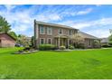 Charming two-story brick home with a well-manicured lawn, lovely landscaping, and a welcoming front entrance at 195 Lake Dr, Greenwood, IN 46142