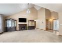Spacious living room with high ceilings, a fireplace, display cabinets, and an open floor plan at 2557 Cedarcrest Dr, Columbus, IN 47203