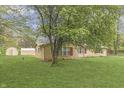 Side view of a single story brick home showing a storage shed in the back yard at 3008 Old State Road 37, Greenwood, IN 46143