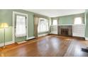 Bright living room with hardwood floors, fireplace, built-in shelves, and natural light at 301 Colescott St, Shelbyville, IN 46176