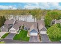 Aerial view of single-Gathering homes backing onto the lake, with well-manicured lawns at 3136 River Bay N Dr, Indianapolis, IN 46240