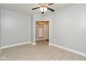 Clean bedroom featuring grey walls, white trim, new laminate flooring, and ceiling fan at 3180 Graceland Ave, Indianapolis, IN 46208
