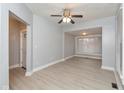 Bright living room featuring grey walls, white trim, new laminate flooring, and a ceiling fan at 3180 Graceland Ave, Indianapolis, IN 46208