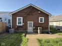 Exterior view of back of brick home with a well-maintained lawn and backyard at 324 E Southern Ave, Indianapolis, IN 46225