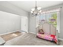 Bright entryway with carpet floors, a chandelier, and a view of the front door at 4264 Amesbury Pl, Noblesville, IN 46062