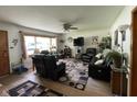 Cozy living room featuring hardwood floors, a ceiling fan, a comfortable sofa, and natural light at 4711 Earlham Dr, Indianapolis, IN 46227