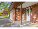 Welcoming front entrance featuring a brick facade, decorative accents, and a covered porch with a white front door at 601 Ridgeview Ln, Columbus, IN 47201