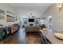 Bright living room with vaulted ceilings, a cozy fireplace, modern furniture and hardwood floors at 6195 Woodmill Dr, Fishers, IN 46038