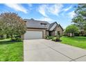 Long driveway leading to a well-maintained brick home with a two-car garage at 621 Thorne Dr, Brownsburg, IN 46112
