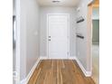Bright entryway showcases elegant wood floors and a coat rack for added functionality at 7108 Burlat Ln, Noblesville, IN 46062