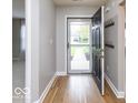 Inviting entryway featuring stylish wood floors and a coat rack for convenience at 7108 Burlat Ln, Noblesville, IN 46062