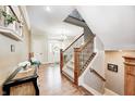 Hardwood foyer with view of stairs, chandelier, decorative tables, and front door at 7653 Carriage House Way, Zionsville, IN 46077