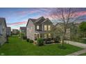 Beautiful two-story home with neutral siding, a front porch, a well-maintained lawn, and mature trees at 7824 Gray Eagle Dr, Zionsville, IN 46077