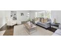 Bright living room featuring contemporary decor, large windows, hardwood floors and stylish furniture at 7950 Westfield Blvd, Indianapolis, IN 46240