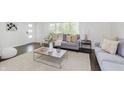 Bright living room featuring contemporary decor, large windows, hardwood floors and stylish furniture at 7950 Westfield Blvd, Indianapolis, IN 46240