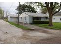 Charming single-story home with light blue siding and a detached garage at 8341 N Washington St, Sheridan, IN 46069