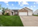 Charming single-story home with brick accents, two-car garage, and well-manicured lawn at 901 Palomino Pl, Bargersville, IN 46106