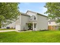Beautiful two-story home with gray siding and a well-maintained lawn, showcasing its inviting curb appeal on a sunny day at 9307 W Dockside Cir, Pendleton, IN 46064
