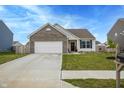 Charming home features a two-car garage, well-manicured lawn, and tasteful landscaping at 932 Sagittarius Ave, Franklin, IN 46131