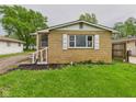 Quaint home with tidy landscaping and attractive yellow brick at 979 Monroe St, Indianapolis, IN 46229