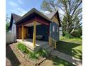 Blue house featuring a cozy porch with colorful columns and a seating area perfect for relaxation at 1050 Jefferson Ave, Indianapolis, IN 46201