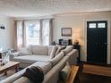Comfortable living room featuring a large sectional sofa, stylish decor, and ample natural light, creating a warm and inviting atmosphere at 106 Walnut St, Southport, IN 46227