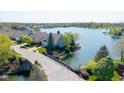 Aerial view overlooking a serene lake and beautiful waterfront homes in a picturesque community at 11484 Lake Stonebridge Ln, Fishers, IN 46037
